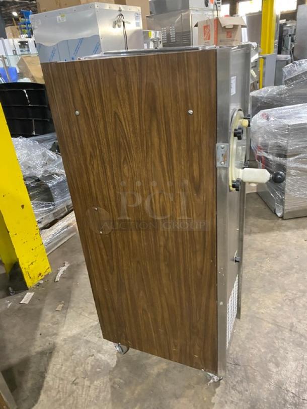 Duke Model 876 single flavor slush machine, electric, stainless steel with wood-style finish, on casters, 115V 1 phase.