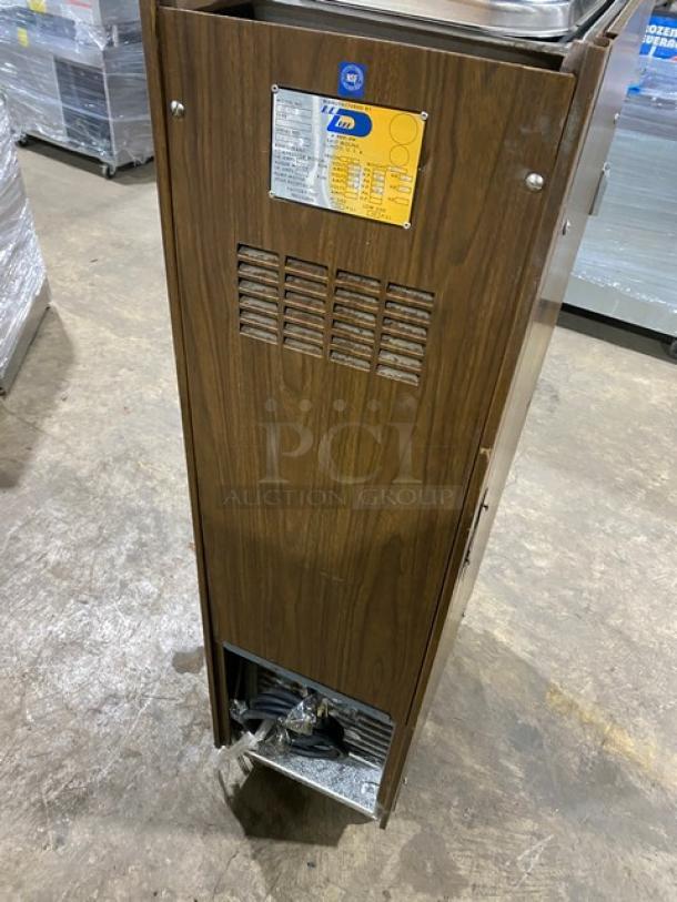 Duke Model 876 slush machine with wooden-style design, stainless steel, on casters, shows vent and label on casing.