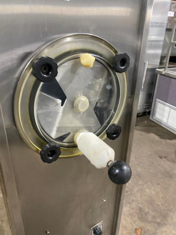 Duke Model 876 stainless steel slush machine, single flavor, electric, 115V 1 Phase, on casters, features wood-style finish.