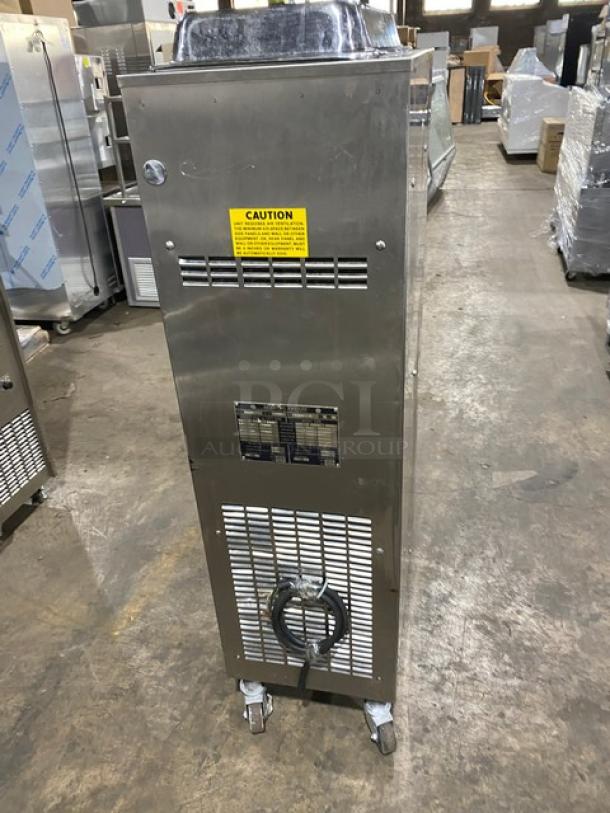 Electro Freeze model 33S-237 stainless steel soft serve machine, single flavor, on casters, 208-230V, 1 phase, caution label visible.