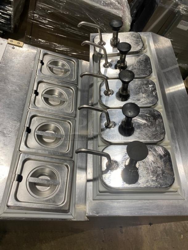 Silver King SKF2A stainless steel single door ice cream topping dispenser with poly coated rack, five pumps, and trays.