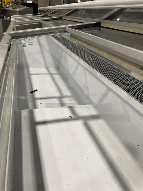 Hussmann LBN8 white commercial freezer, 4 sliding glass doors, model LBN8, SN: MY11B004683, 115V 1 Phase, like-new condition.