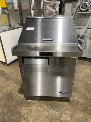 Atosa stainless steel single-door refrigerated prep table, model MSF8305GR, on casters with poly-coated rack.