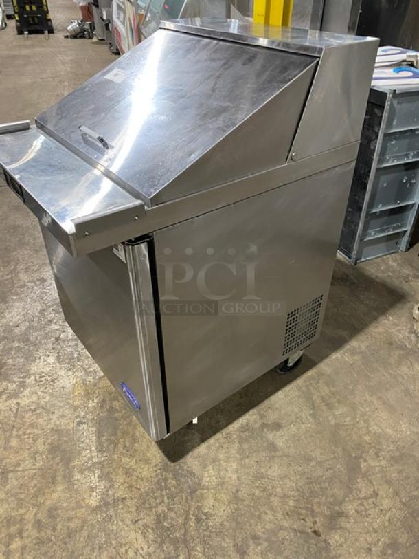 Atosa stainless steel single door refrigerated prep table, model MSF8305GR, on casters, with poly-coated rack.