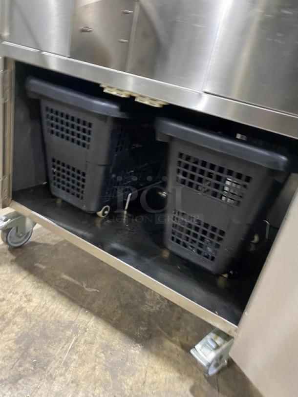 Zummo Z40CN citrus juicer machine with dual cabinet combo, stainless steel, on casters, featuring drip tray and storage bins.