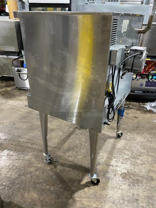 Imperial commercial stainless steel natural gas convection oven on casters, features a wired rack. Appears well-maintained.