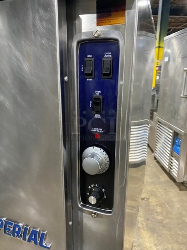 Stainless steel Imperial commercial convection oven on casters with control panel, wired rack, natural gas powered, excellent condition.