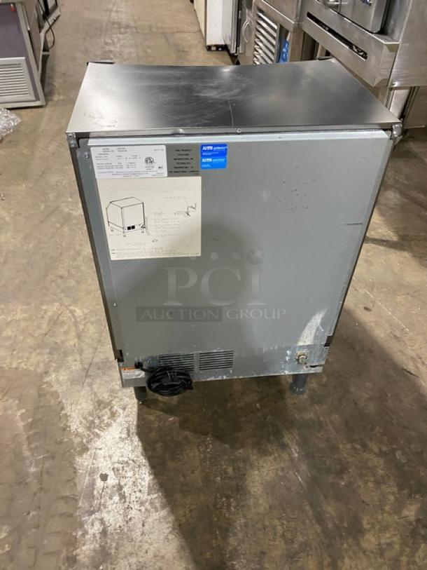 Manitowoc UD0140A stainless steel undercounter ice maker, 115V, 1 Phase, on legs, in used condition, model and serial tags visible.