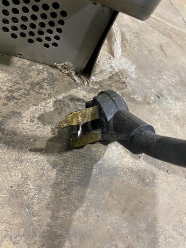 TurboChef NGC commercial oven, ventless, stainless steel, electric-powered, 208/240V plug shown, on concrete floor.