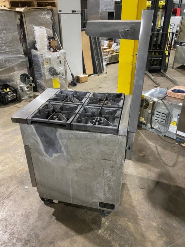 CPG stainless steel 4-burner range/oven combo with backsplash, overhead salamander shelf, on casters. Natural gas powered.