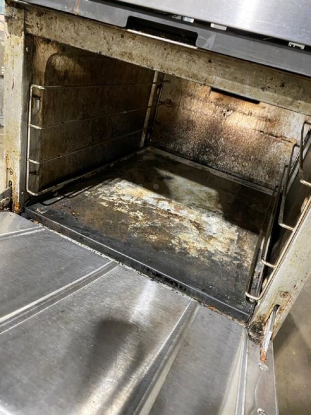 CPG commercial stainless steel oven interior showing signs of wear. Natural gas-powered with a 4-burner range.