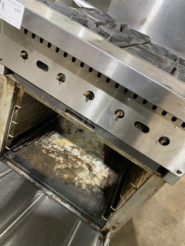 CPG commercial stainless steel 4-burner range/oven combo with back splash, overhead salamander shelf, and casters. Visible wear.