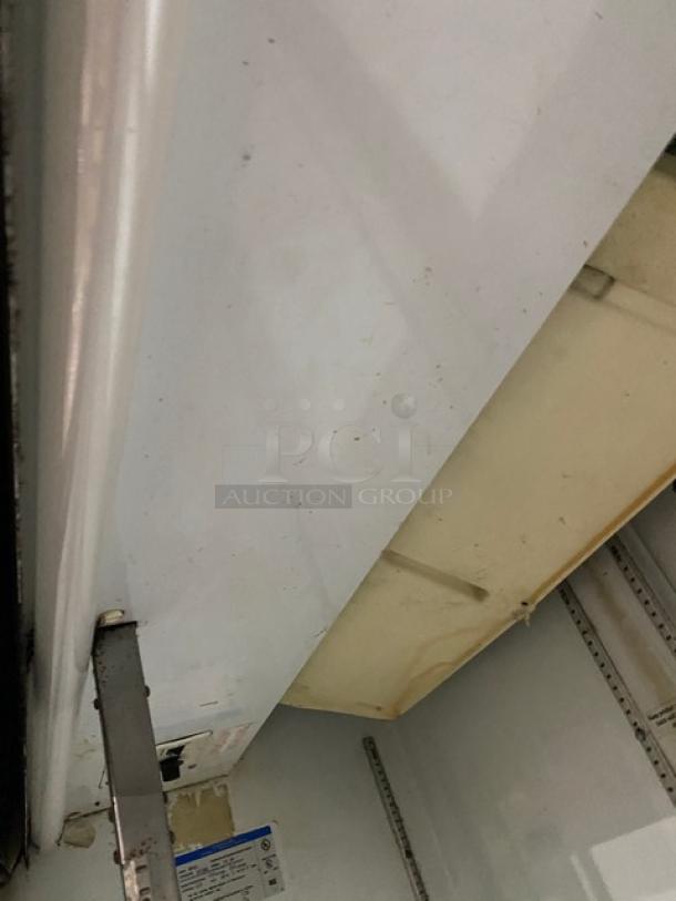 Beverage-Air MT45 commercial refrigerator, white, double glass sliding doors, poly coated wired rack, model and serial label visible.