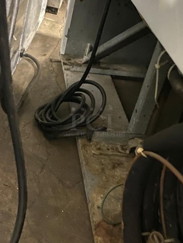 Beverage-Air MT45 commercial refrigerator base, showing power cord coiled on the floor. Model SN: 5263195, 115V, 1 Phase.