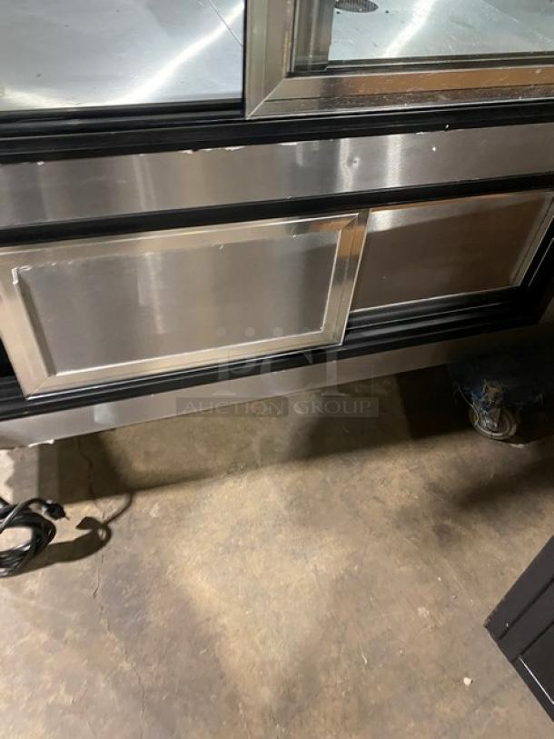 Leader NRHD96 stainless steel 96" refrigerated meat/deli display case with curved glass, rear sliding doors, overstock storage.