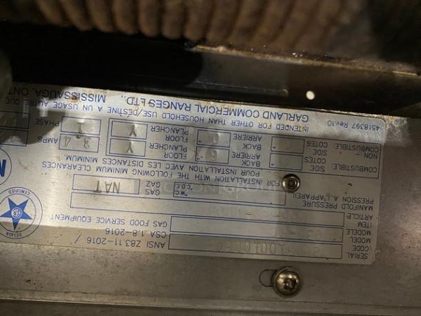 Garland Commercial Stainless Steel Gas Range, Model G36-6C, with 6 burners, oven, backsplash, and overhead salamander shelf.