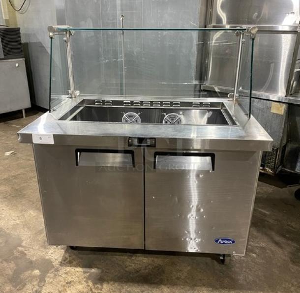 Atosa MSF8306 stainless steel 2-door refrigerated prep table, with sneeze guard and poly-coated rack, on casters.