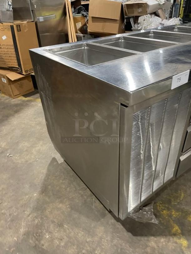 Delfield stainless steel 4-drawer refrigerated salad bar, model 18MC68P-EF, with 5 cold wells and enclosed undershelf, on casters.