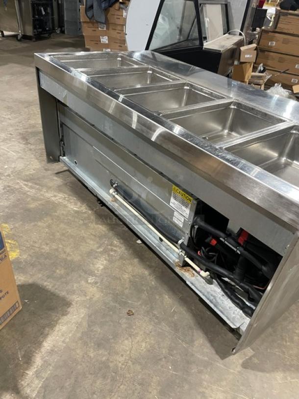 Delfield stainless steel 4-drawer refrigerated salad bar, model 18MC68P-EF, on casters, with 5 wells and enclosed undershelf.
