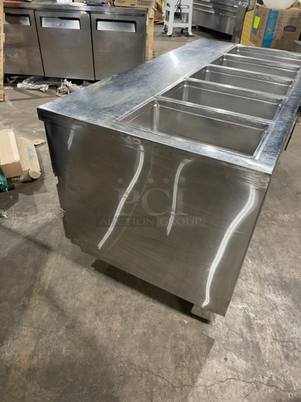 Delfield stainless steel 4-drawer refrigerated food bar, model 18MC68P-EF, with 5 wells, enclosed undershelf, on casters.