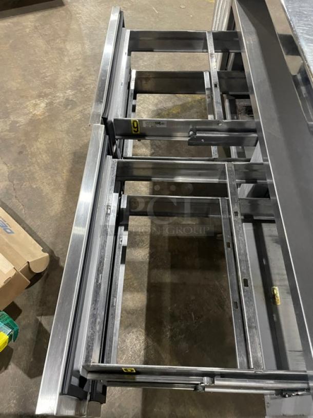 Delfield stainless steel 4-drawer refrigerated salad bar with enclosed undershelf, model 18MC68P-EF, on casters.