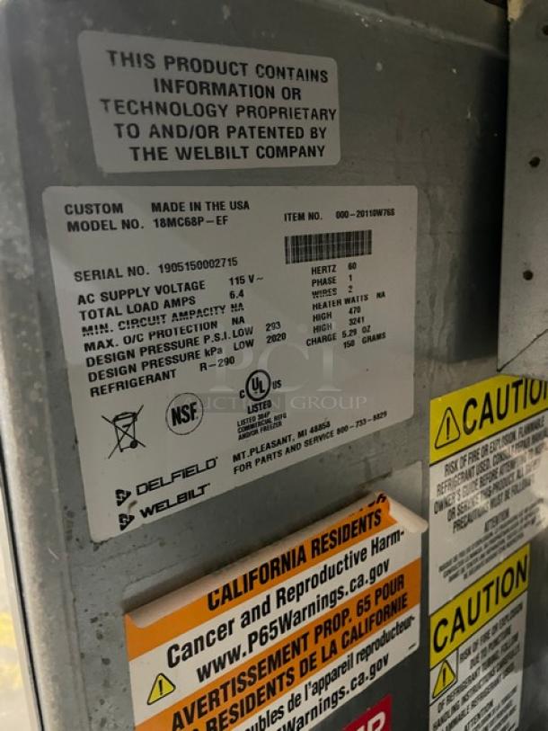 Delfield stainless steel refrigerated salad bar, model 18MC68P-EF. Features 4 drawers, 5 wells, enclosed undershelf, on casters. Serial: 1905150002715. Made in USA.