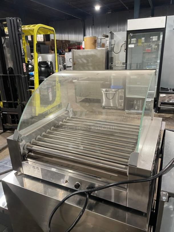 Festival Commercial Stainless Steel Hot Dog Roller, Model ETR211, with curved sneeze guard, 110V, in good condition.