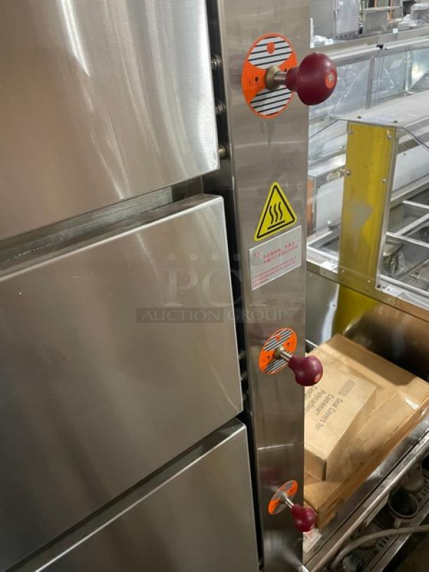 Flame-Mate ESC-3N-N stainless steel 3-compartment natural gas steam cabinet, on legs, with control knobs and caution label.