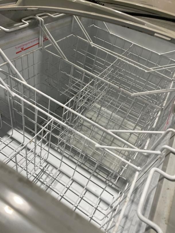 Excelente 2018 commercial curved top ice cream freezer; model CF-289. Includes double sliding glass top, poly-coated wire baskets, and casters.