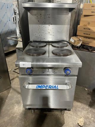 Imperial 4-burner stainless steel range/oven combo with backsplash, overhead salamander shelf, and wire oven rack.