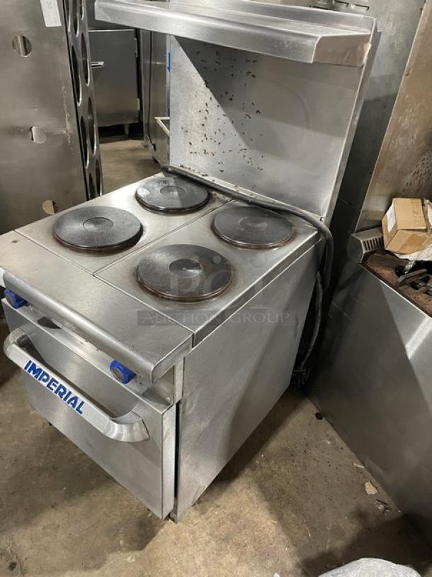 Imperial stainless steel 4-burner hot plate range/oven combo with backsplash, overhead salamander shelf, wire oven rack, on legs.