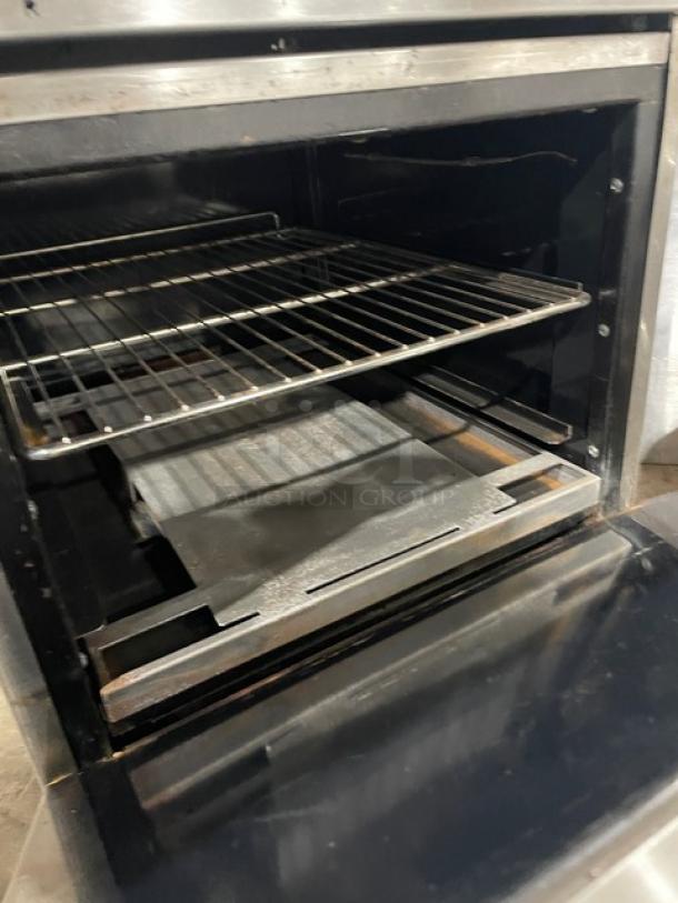 Imperial commercial stainless steel oven interior, featuring a wire rack, clean condition. Part of electric 4-burner range combo.