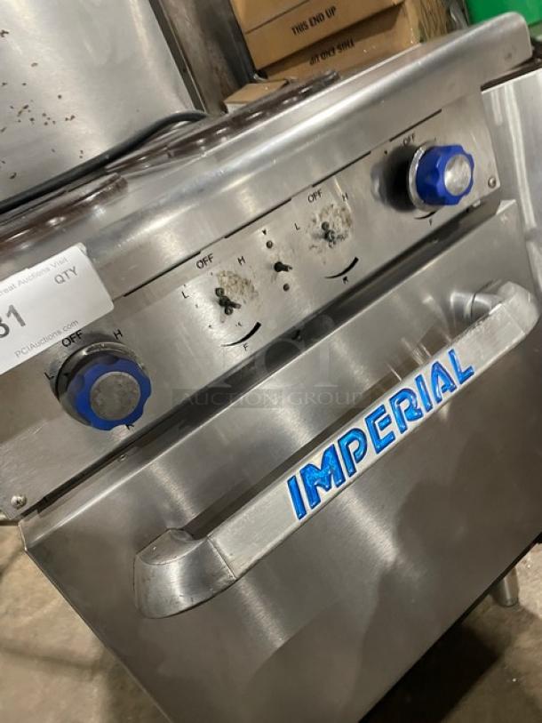 Imperial stainless steel 4-burner hot plate range/oven combo. Features backsplash, overhead salamander shelf, and wire oven rack. Electric powered, on legs.