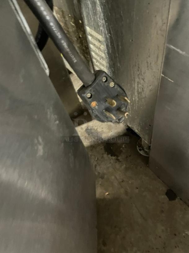 Imperial commercial electric plug and rear details of stainless steel 4-burner hot plate range/oven combo.