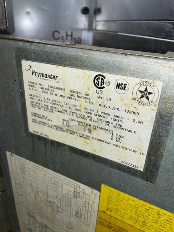 Fry Master commercial stainless steel fryer, model FMP145ESC, 2-bay, natural gas, 110-120V, on casters, with label showing specifications.