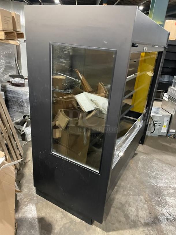 Federal Industries black multi-tier refrigerated merchandiser, model RSSM678SC-5, with pull-down night curtain, used condition.