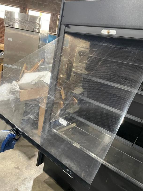 Federal Industries RSSM678SC5 black refrigerated display case with pull-down night curtain, open multi-tier shelves.