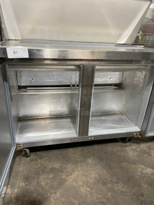 Continental stainless steel 2-door refrigerated prep table, model SW48-18M, on casters. Internal shelving, good condition.