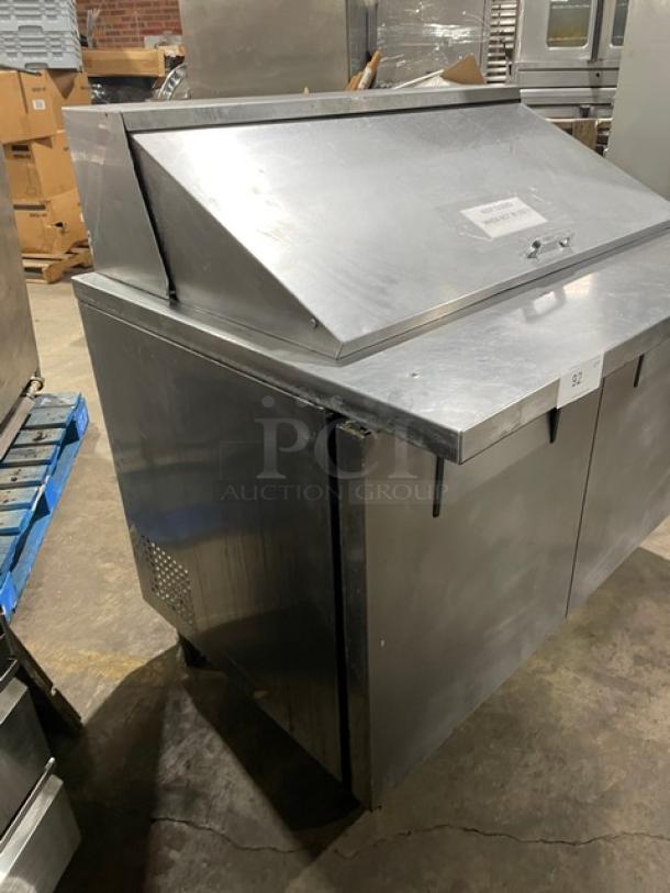 True TSSU-48-18M-B refrigerated prep table with 2 stainless steel doors, poly-coated racks, on casters, model 7037531.