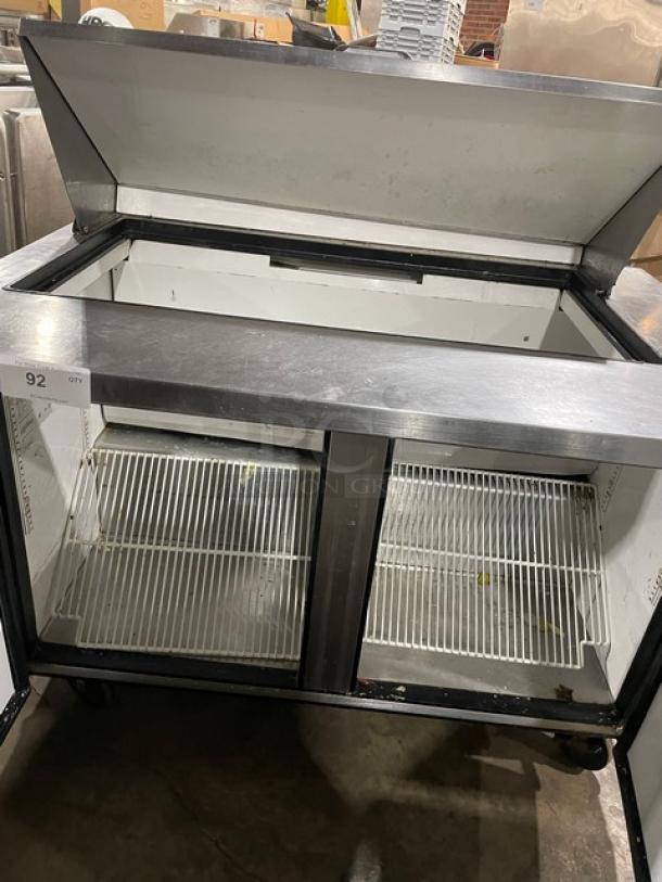 True TSSU-48-18M-B stainless steel 2-door refrigerated prep table with poly-coated racks, used condition, model on casters.