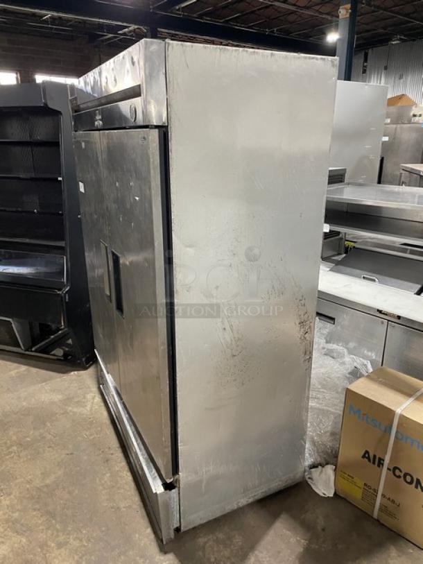 True T-49F commercial stainless steel 2-door reach-in freezer, with poly-coated wire rack, visible wear, 115V, 1 phase.