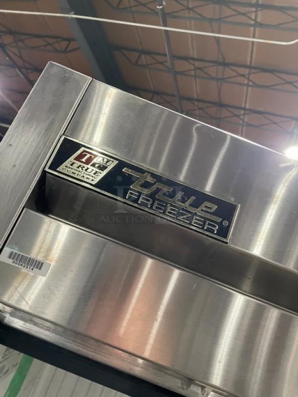 True T-49F stainless steel 2-door reach-in freezer, commercial grade, with poly-coated wired rack. Visible brand label.