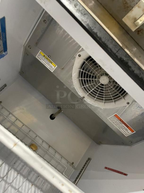Beverage-Air KF24-1AS commercial freezer interior, showing a poly coated wire rack and cooling fan on the ceiling.
