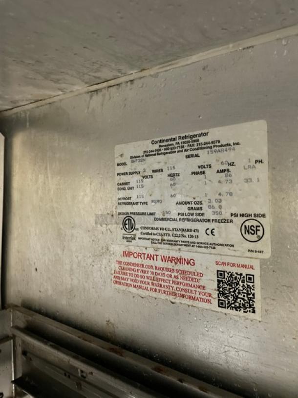 Continental SWF32N commercial stainless steel 2-drawer undercounter freezer, model label showing specs, on casters.