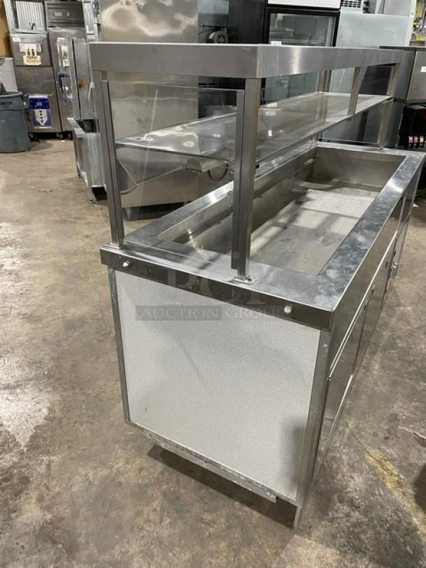 Servolift Stainless Steel Refrigerated Salad Bar, Model 502-5R-CW, with overhead sneeze guard, cabinet base, and casters.