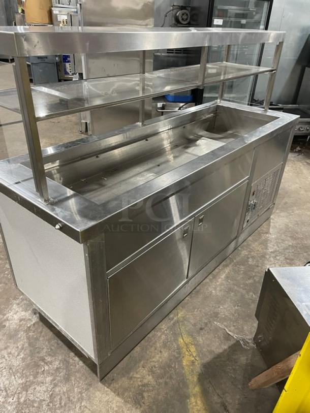 Servolift stainless steel refrigerated cold food/salad bar with sneeze guard, overhead shelf, and cabinet base. Model 5055RCW.