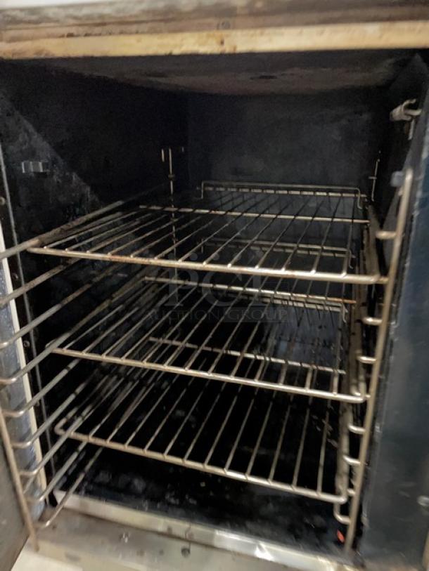 Vulcan stainless steel double stacked convection oven, natural gas, with wired oven rack, on legs. Used condition.