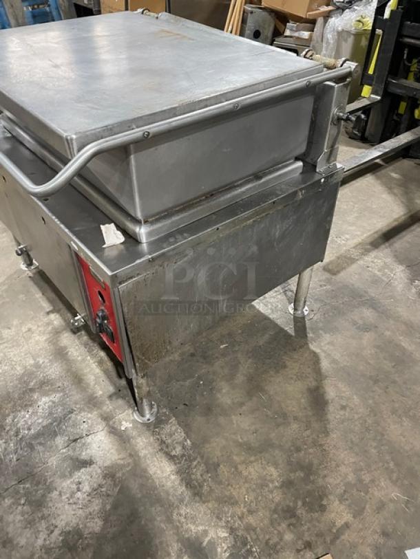 Vulcan Commercial stainless steel tilt skillet, natural gas powered, on legs. Features control panel and sturdy construction. Moderate wear.