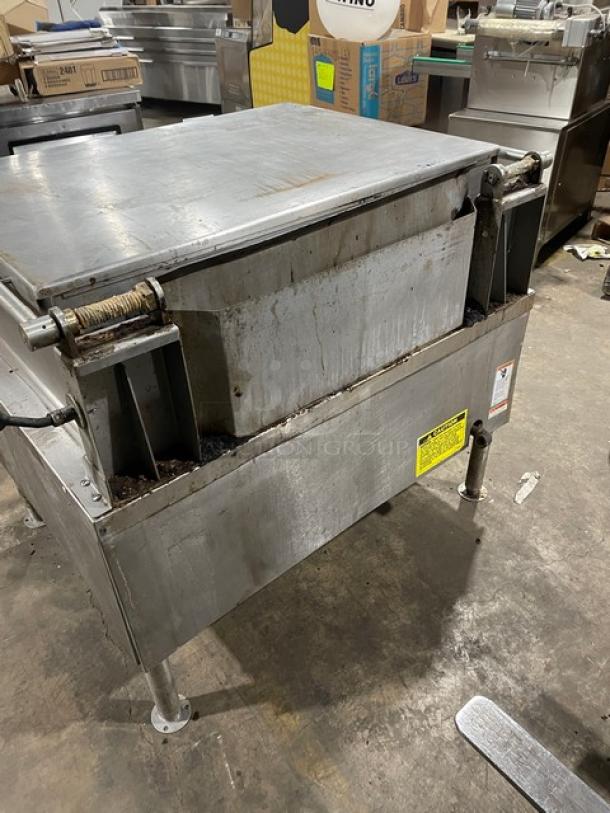 Vulcan commercial stainless steel gas-powered tilt skillet on legs, used condition, visible wear, with safety and operation labels.