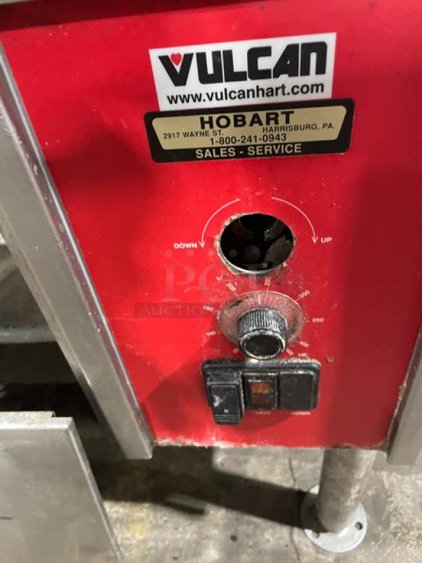 Vulcan commercial stainless steel natural gas tilt skillet, visible controls, Hobart service label, on sturdy legs.